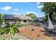 The backyard offers lots of landscaping, a garden and patio area, and privacy at 13411 Whitby Rd, Hudson, FL 34667