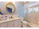 Renovated bathroom with marble vanity, walk-in shower, decorative mirror and fixtures at 13411 Whitby Rd, Hudson, FL 34667