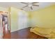 Well-lit bedroom features a ceiling fan, closet, and laminate floors at 13411 Whitby Rd, Hudson, FL 34667