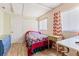 Simple bedroom with door, window and neutral decor at 13411 Whitby Rd, Hudson, FL 34667