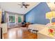 Cozy bedroom with wood floors, a vaulted ceiling, and sunlit windows overlooking a lush garden at 13411 Whitby Rd, Hudson, FL 34667