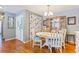 Bright dining room features a white table, chairs and a glass front china cabinet at 13411 Whitby Rd, Hudson, FL 34667