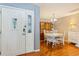 Bright dining room with a front door view features a white table with chairs at 13411 Whitby Rd, Hudson, FL 34667