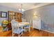 Cozy dining area includes a white round table and is lit by a chandelier at 13411 Whitby Rd, Hudson, FL 34667