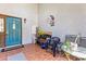 Inviting front porch with tile flooring and a stylish blue door, perfect for outdoor relaxation at 13411 Whitby Rd, Hudson, FL 34667