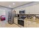 Well-equipped kitchen with stainless steel appliances, granite counters, and ample cabinet space at 13411 Whitby Rd, Hudson, FL 34667