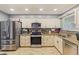 Modern kitchen with stainless steel appliances, granite counters, and tiled backsplash at 13411 Whitby Rd, Hudson, FL 34667