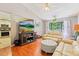 Cozy living room features hardwood floors, a large window, and comfortable seating at 13411 Whitby Rd, Hudson, FL 34667