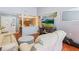 Open living room with hardwood floors offers ample natural light and entertainment space at 13411 Whitby Rd, Hudson, FL 34667
