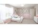 Bright bedroom featuring a charming canopy bed, soft pink accents, and a decorative name art at 2770 Walden Town Cir, Plant City, FL 33566