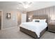 Bedroom featuring a paneled accent wall, wood furniture, and a comfortable white bed set at 2770 Walden Town Cir, Plant City, FL 33566