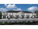 Attractive townhome exteriors boast a gray palette, private garages, and manicured landscaping at 2770 Walden Town Cir, Plant City, FL 33566