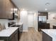 Modern kitchen with stainless steel appliances, granite countertops, and wood-look floors at 2770 Walden Town Cir, Plant City, FL 33566