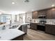 Open kitchen with stainless steel appliances and countertop seating adjacent to living space at 2770 Walden Town Cir, Plant City, FL 33566