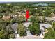 Aerial view showcasing property with pool and lake in the distance amid surrounding trees at 2872 Hammock Dr, Plant City, FL 33566
