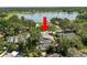 Aerial view showcasing property with pool and lake in the distance amid surrounding trees at 2872 Hammock Dr, Plant City, FL 33566