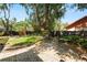 The landscaped backyard offers a brick patio, black fencing, lawn, and mature trees at 2872 Hammock Dr, Plant City, FL 33566