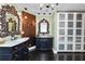 Bathroom featuring double vanities, a decorative wall, and white closets at 2872 Hammock Dr, Plant City, FL 33566
