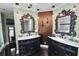 Bathroom featuring double vanities, decorative mirrors, and textured wall accents at 2872 Hammock Dr, Plant City, FL 33566