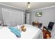 Cozy bedroom features a closet, a TV, and a decorative desk and chair at 2872 Hammock Dr, Plant City, FL 33566