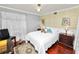 Bright bedroom features a bed with hardwood floors and natural light from a window at 2872 Hammock Dr, Plant City, FL 33566