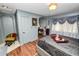 Elegant bedroom with a decorative archway, ornate wall details, and hardwood floors at 2872 Hammock Dr, Plant City, FL 33566