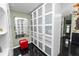 Walk-in closet featuring custom built-in closet system and a red stool at 2872 Hammock Dr, Plant City, FL 33566