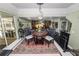 Bright dining area with decorative rug and views of the outdoors and adjacent living spaces at 2872 Hammock Dr, Plant City, FL 33566