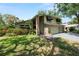 Charming two-story home with lush landscaping, awning-covered windows, and an attached two-car garage at 2872 Hammock Dr, Plant City, FL 33566
