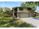 Charming two-story home with lush landscaping, awning-covered windows, and an attached two-car garage at 2872 Hammock Dr, Plant City, FL 33566
