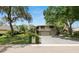 Charming two-story home with lush landscaping, awning-covered windows, and an attached two-car garage at 2872 Hammock Dr, Plant City, FL 33566