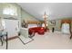 View of the foyer features elegant furnishings, a red curved sofa, and decorative chandelier at 2872 Hammock Dr, Plant City, FL 33566