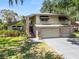 Two-story house with a brick facade, garage, and a beautiful lawn at 2872 Hammock Dr, Plant City, FL 33566