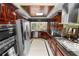 Gourmet kitchen boasts custom cabinets, granite countertops, and stainless steel appliances at 2872 Hammock Dr, Plant City, FL 33566