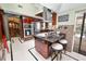 Stylish kitchen island features seating, storage, and stainless appliances; adjacent dining area at 2872 Hammock Dr, Plant City, FL 33566