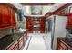 Spacious kitchen with custom cabinets, stainless steel refrigerator, and built-in desk area at 2872 Hammock Dr, Plant City, FL 33566