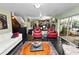 Open-concept living space featuring an elegant rug, comfortable seating, and a view into the kitchen at 2872 Hammock Dr, Plant City, FL 33566