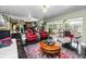 Bright living area featuring red accents, comfortable seating, and seamless access to the outdoor pool area at 2872 Hammock Dr, Plant City, FL 33566