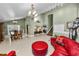 Open concept design featuring a living room and dining room with a large red leather sofa and tiled floors at 2872 Hammock Dr, Plant City, FL 33566