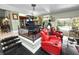Open-concept living space featuring comfortable seating, and a view into the kitchen and the outdoor pool area at 2872 Hammock Dr, Plant City, FL 33566