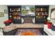 Living room with black built-in bookcases and brick fireplace. A TV is mounted above the fireplace mantle at 2872 Hammock Dr, Plant City, FL 33566