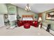 Bright living room with elegant decor, large red leather sofa, tiled floors, and unique design accents at 2872 Hammock Dr, Plant City, FL 33566