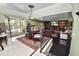Open-concept living space featuring comfortable seating, and a view into the dining room and the outdoor pool area at 2872 Hammock Dr, Plant City, FL 33566