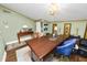 Office showcasing an oversized desk, an elegant chandelier, and ample lighting at 2872 Hammock Dr, Plant City, FL 33566