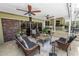 This outdoor living space features stone floors, comfortable seating, and overlooks the pool and landscaped yard at 2872 Hammock Dr, Plant City, FL 33566