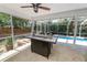 This outdoor living space features stone floors, a custom fire pit, and overlooks the pool and landscaped yard at 2872 Hammock Dr, Plant City, FL 33566