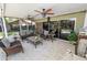 This outdoor living space features stone floors, comfortable seating, and overlooks the pool and landscaped yard at 2872 Hammock Dr, Plant City, FL 33566