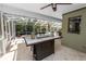 This outdoor living space features stone floors, a custom fire pit, and overlooks the pool and landscaped yard at 2872 Hammock Dr, Plant City, FL 33566