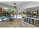 Inviting screened patio offers an outdoor dining area, cozy sitting area, and a view of the sparkling pool at 2872 Hammock Dr, Plant City, FL 33566