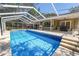 Large screened pool with jacuzzi, outdoor kitchen, and bar offers a resort-style outdoor living space at 2872 Hammock Dr, Plant City, FL 33566